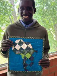School boy with quilt